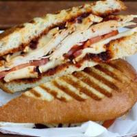 Turkey Panini · Roasted turkey breast, melted brie, tomato, and house made pepper jam.