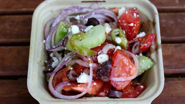 Greek Salad · Kalamata olives, feta, red onion, and tomatoes with lemon oregano dressing.