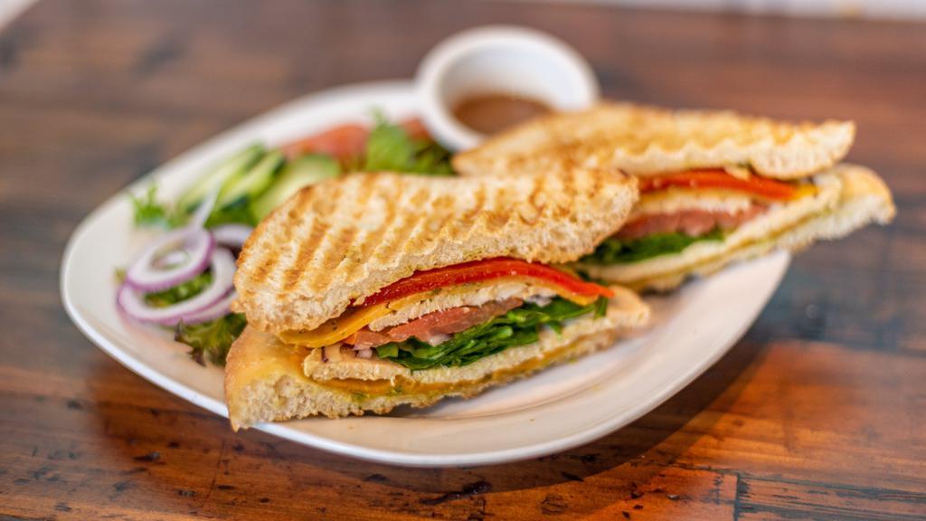 Grilled Veggie Panini on Ciabatta Bun with Provolone · serve on pressed grilled ciabatta bread with grilled eggplant, portobello mushroom, grilled zucchini, baby spinach, roasted red pepper mozzarella cheese, house spread and side of mixed green salad with balsamic vinaigrette dressing