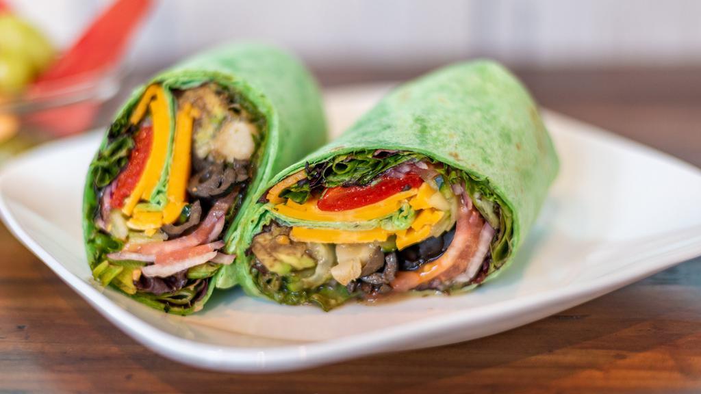 Veggie Wrap · baby spinach, avocado, tomato, cucumber, black olives, artichoke heart, red onion, roasted red pepper Swiss cheese, a drizzle of balsamic vinaigrette dressing on spinach tortilla and side of mixed fruit