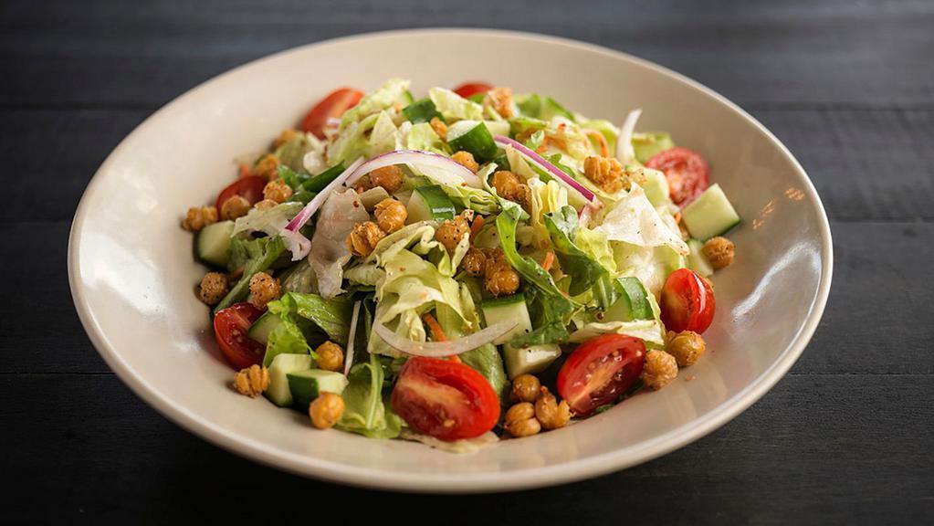 House Salad · Mixed greens, grape tomatoes, shredded carrots, cucumbers, and red onions, tossed in our house dressing. Topped with crispy garbanzo beans.
