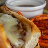 French Dip · Shaved ribeye seasoned and seared, caramelized onions, melted swiss cheese, and garlic aioli...