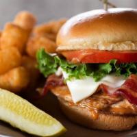Chipotle Chicken Sandwich · Grilled beer-brined chicken breast smothered in bacon, swiss cheese, and chipotle sauce, ser...