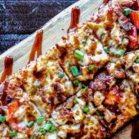 BBQ Chicken Flatbread · Tender, grilled chicken with onions, peppers, and bacon smothered in mozzarella cheese. Fini...