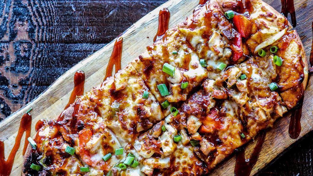 BBQ Chicken Flatbread · Tender, grilled chicken with onions, peppers, and bacon smothered in mozzarella cheese. Finished with a drizzle of chipotle BBQ.