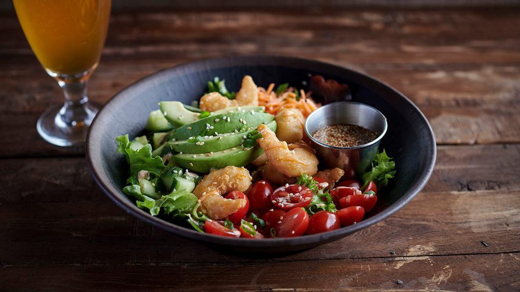 The Cali Bowl · Your choice of protein over spring greens, with grape tomatoes, shredded carrots, cucumbers, drizzled with sriracha-lime aioli and topped with fresh avocado, toasted sesame seeds, and scallions. Served with a side of sesame soy sauce.