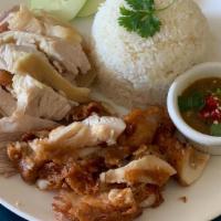 Combo Khao Mun Gai · Poached chicken and fried chicken over rice with sauce.