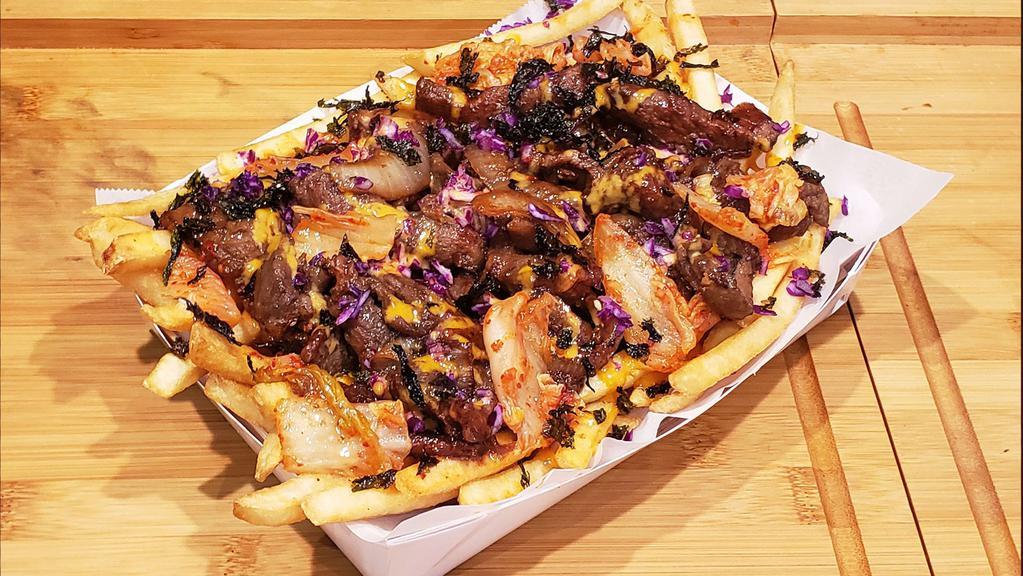 Korean BBQ Beef Fries · Pan Fried Bulgogi Beef, House Korean Sauce, Diced Tomatoes, Red Cabbage, and Seaweed Flakes o/ Bed of Crispy Fries.