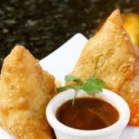 Samosa (2 Pieces) · Vegan. Fried triangular dough stuffed with potatoes, peppers, and cilantro seeds. Served wit...