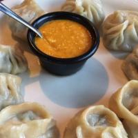 Chicken Momo (8 Pieces) · Steamed dumplings filled with minced chicken, onion, garlic, ginger, and cilantro.  Served w...