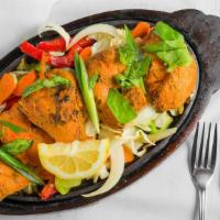 Chicken Tandoori .G · Chicken marinated in yogurt and spices, broiled in the tandoor oven and served with sautéed ...