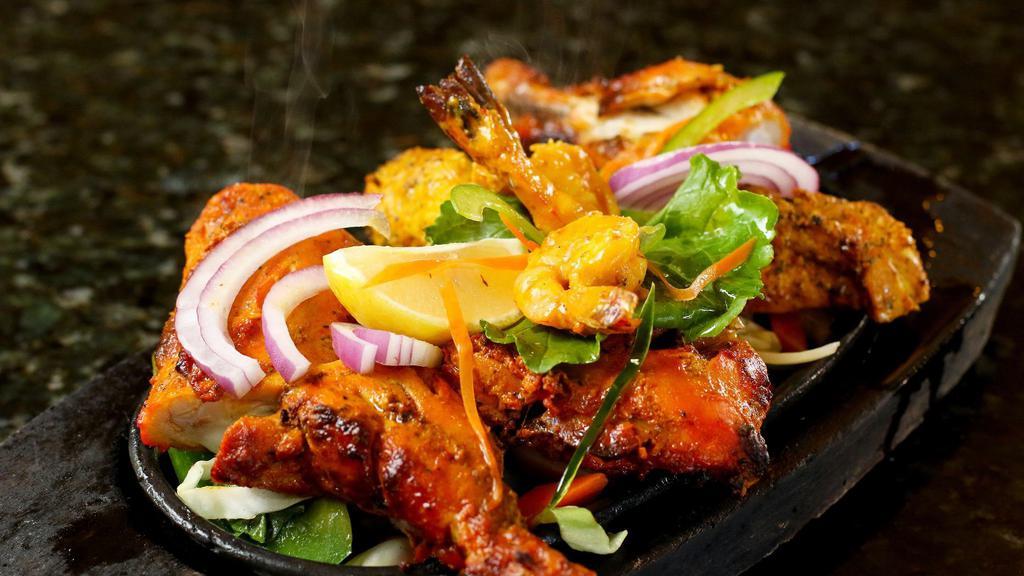 Chicken Tandoori Tikka · Boneless chicken breast first marinated with special herbs, spices along with yogurt. Then baked to perfection in the tandoor oven.