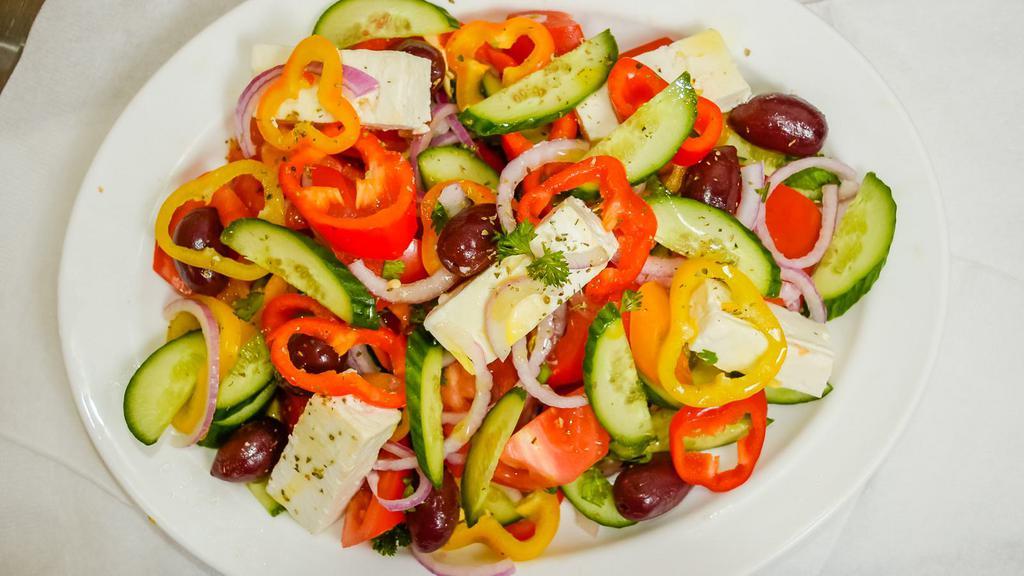 GREEK  SALAD · Authentic Greek salad, tomatoes, onions, cucumbers, feta cheese, kalamata olives, peppers, Greek oregano, olive oil and balsamic vinegar  &  Pita  Bread