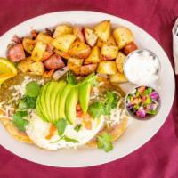 Huevos Rancheros · Two crispy tortillas topped with refried beans, two eggs, chile verde sauce, jack cheese and...