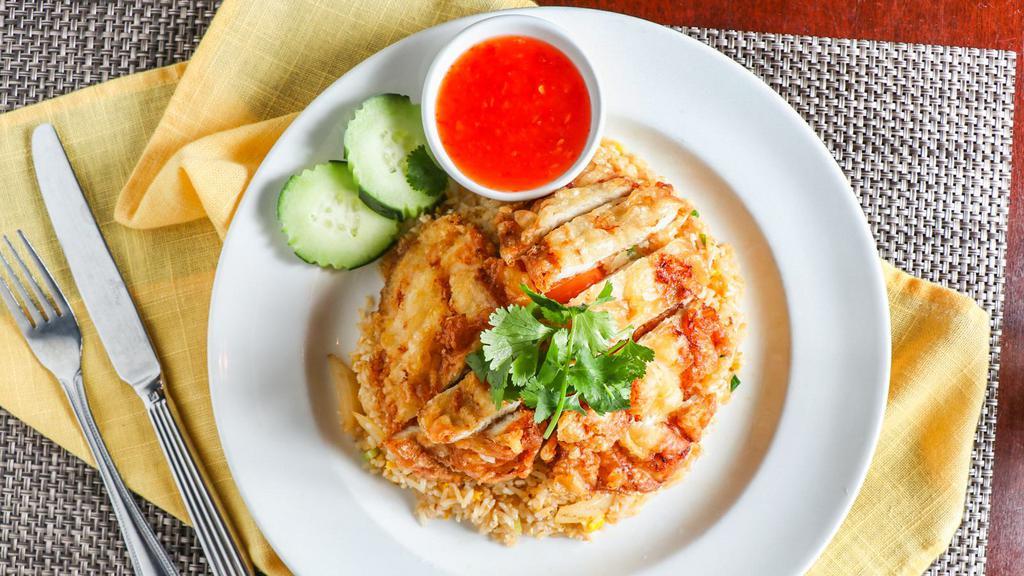 Fried Chicken Over Fried Rice · Deep fried marinated boneless chicken topped over Thai fried rice.