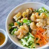 Wild Gulf Shrimp Vermicelli · Wok stir fried wild shrimp, garlic, and green onions, served over a bed of red oak lettuce, ...