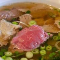 Pho bo, Vietnamese beef soup · Hot soup of grass fed beef bone broth, served with thin rice noodles, sliced braised beef, a...