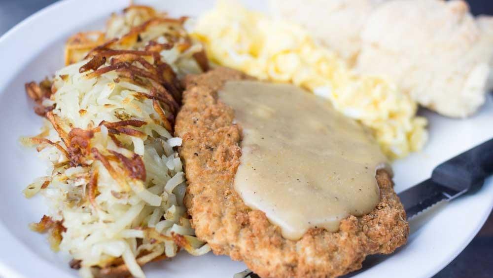 Chicken Fried Steak · Breaded beef cutlet smothered in poultry gravy. Served with 2 eggs any style, potatoes or grits and biscuits or toast.