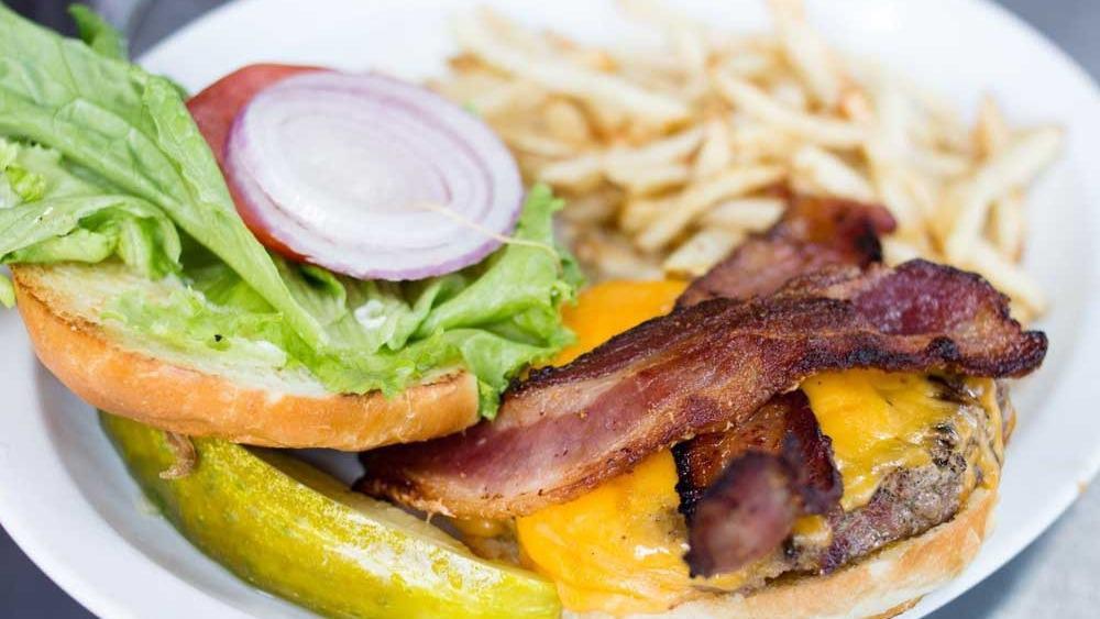 Bacon Cheeseburger · 8oz beef patty hickory smoked bacon, sharp cheddar, . Served on brioche buns with tomato, lettuce, red onions and side dill pickle served with fries or salad.