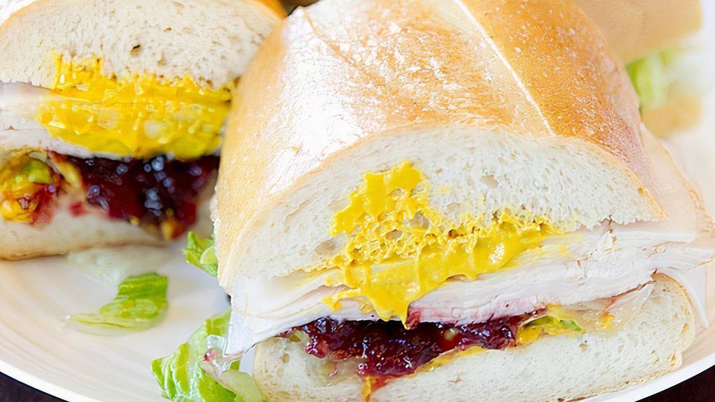 Turkey & Cranberry Sandwich · Includes mayonnaise, mustard, lettuce, tomato, pickle, onion and our sun-dried tomato tapenade.