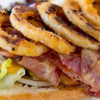 Wrangler Burger · Cheddar cheese, bacon, onion rings and BBQ sauce. Includes mayonnaise, mustard, lettuce, tom...