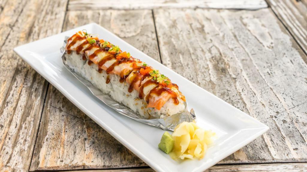 Lion King Roll · Imitation crab, avocado topped baked salmon, Parmesan cheese, and masago and unagi sauce.
