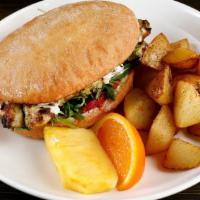 Chicken Sandwich · Toasted ciabatta bun, grilled chicken thigh, tzatziki, arugula, house sauce, pickled onions ...