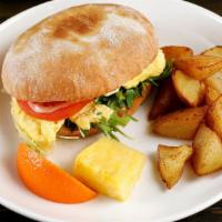 Breakfast Sandwich · Toasted bun, two feta scrambled eggs, arugula, tomatoes, house sauce & crispy potatoes (Nut-...