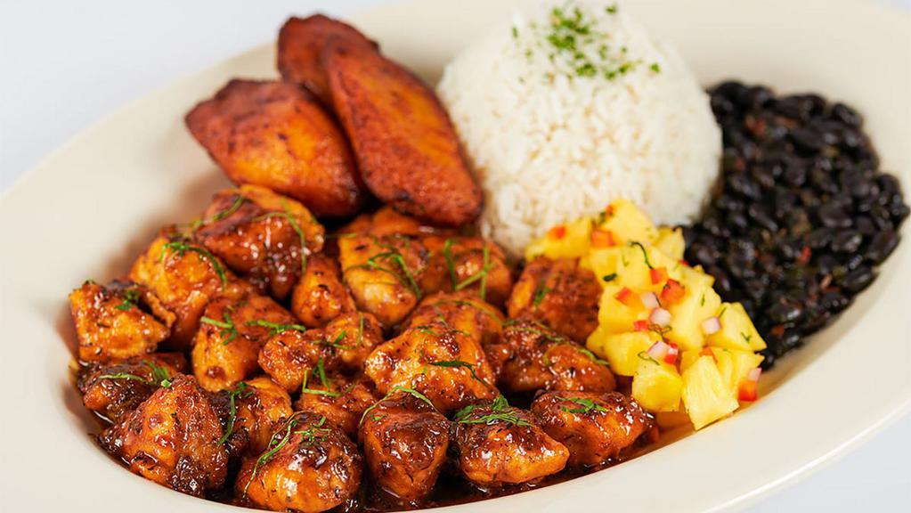 Jamaican Black Pepper Chicken · Chicken with a very spicy Jamaican black pepper sauce. Served with rice, black beans, plantains and marinated pineapple.