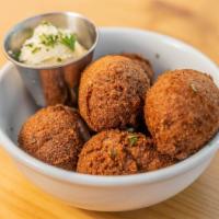 Hush Puppies · Traditional cornmeal fritters with honey butter.