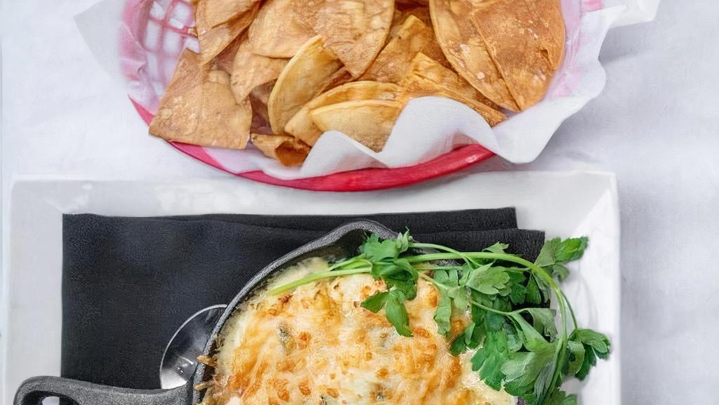 Artichoke Crab Dip · Crab, cream cheese, artichoke, spinach, and parmesan cheese.  Accompanied with toastada chips.