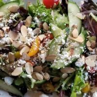 House Salad · Mixed greens, tomatoes, cucumbers, toasted almonds, and feta cheese.