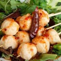 Look Chin Tod · Deep fried fishballs on stick along with mixed spring, cucumber, cilantro, and Pintoh’s spic...