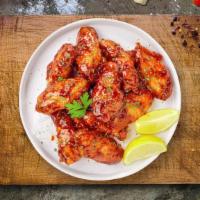 Honey Bee Wings · Fresh chicken wings breaded, fried until golden brown, and tossed in honey. Served with a si...