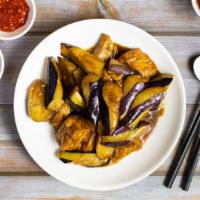Eggplant, Tofu & Basil W/ Satay Sauce · Eggplant, and fried tofu stir fried in a satay peanut sauce. Garnished with basil.