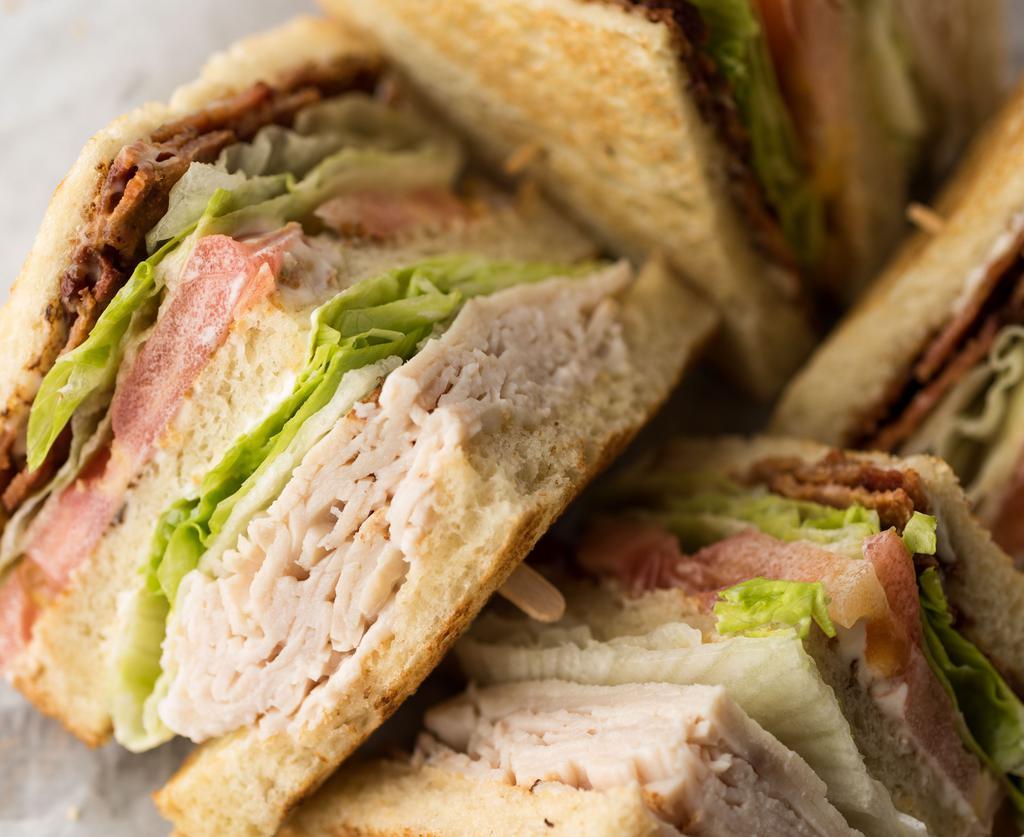 Our Famous Club · Choice of toasted white, wheat or sourdough bread.                     Towering sandwich with three slices of bread by combining our Turkey and BLT.