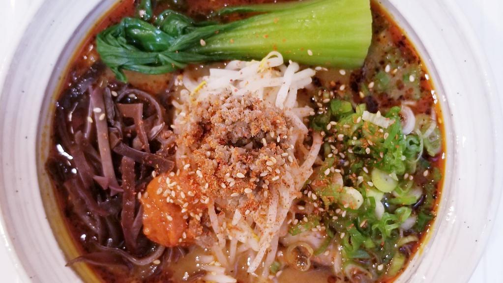Spicy Miso Ramen · Our chicken and pork bones broth and topped with spicy miso sauce, chili oil topped with pork chasu. ground pork, green onion, cabbage, chili pepper, sesame seed, bok choy, kikurage, mung bean sprouts.