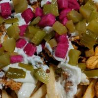 Chicken Shawarma Fries · French fries topped with chicken shawarma, turnip and cucumber pickles and Toum
