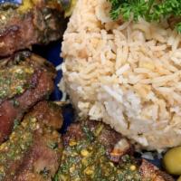 Lamb Chops · Gluten free. Topped with chermoula sauce and served with basmati rice and vegetables.