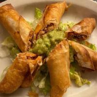 Chimichanguitas · Deep-fried flour tortillas filled with chicken or picadillo. Served with guacamole and lettu...