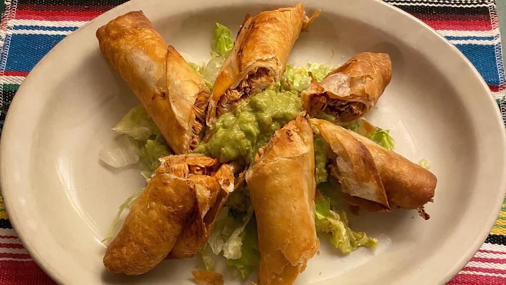 Chimichanguitas · Deep-fried flour tortillas filled with chicken or picadillo. Served with guacamole and lettuce.