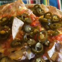 Regular Nachos · Corn tortilla chips, beans, jalapeño peppers, melted cheese and chopped tomato.