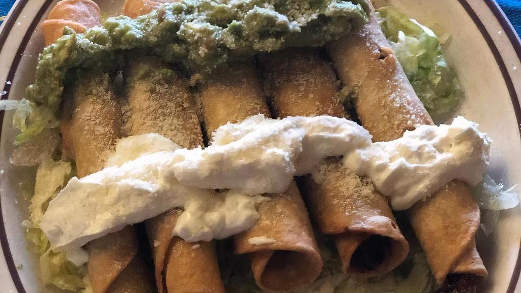 Fried Taquitos · Five deep-fried chicken or shredded beef taquitos. Served on a bed of lettuce. Topped with sour cream, guacamole and cotija cheese.