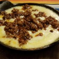 Queso Fundido · Melted cheese served sizzling hot with chorizo. Chips served on the side