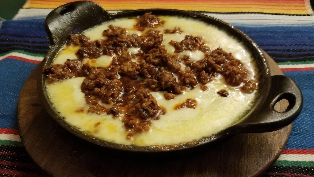Queso Fundido · Melted cheese served with chorizo.
