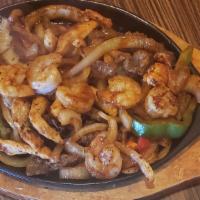 Supremas Fajitas · The ultimate chicken, steak, and shrimp sautéed with onions, carrots, and bell peppers. Serv...