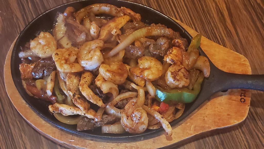 Sunday - Fajitas Supremas · The ultimate fajitas, steak, chicken, and shrimp sizzling hot over a bed of sautéed onions, carrots, and bell peppers. Served with rice, beans, sour cream, guacamole and tortillas.