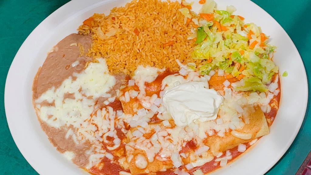Two Crab Enchiladas · Crab filled enchiladas topped with red sauce, sour cream and onions. Served with rice, beans and tortillas.