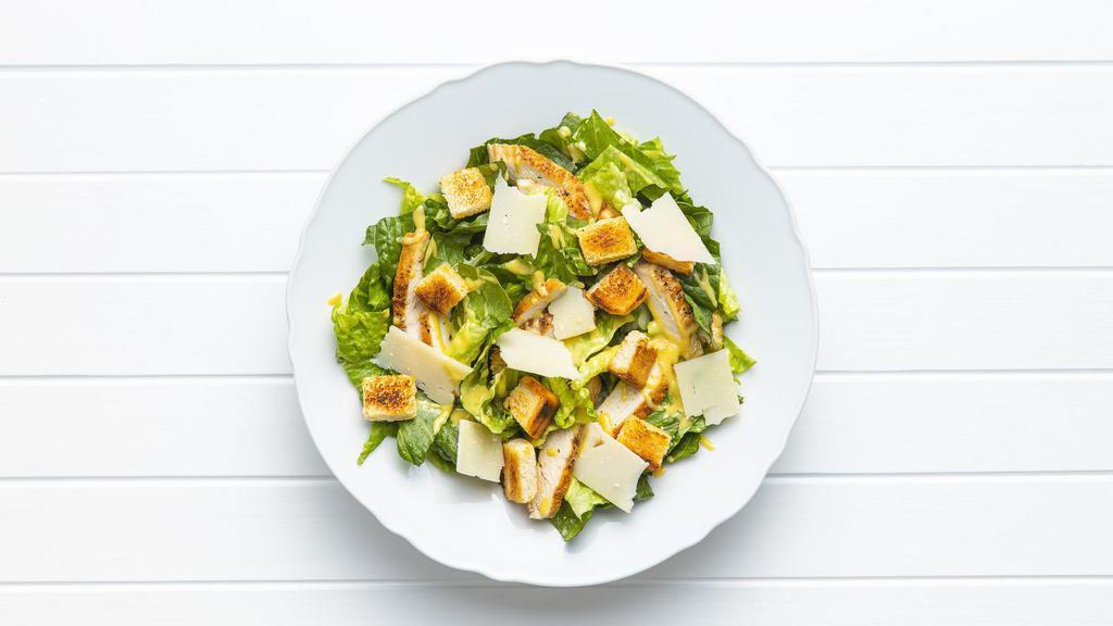 Grilled Chicken Caesar Salad · Grilled chicken, crispy lettuce, cheese, and herb croutons served with a side of caesar dressing