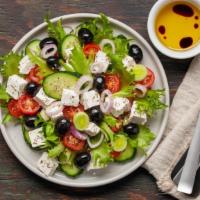 Greek Salad · Fresh lettuce, tomatoes and onions, feta cheese and olives.